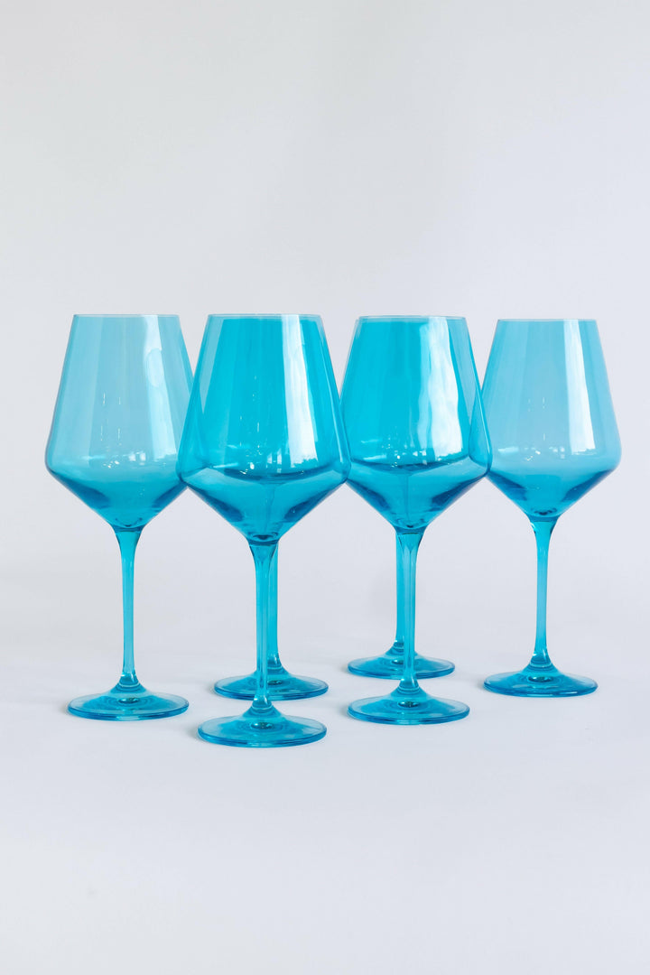Elegant ocean blue wine glasses set on a pristine table, capturing the essence of luxury and coastal charm.