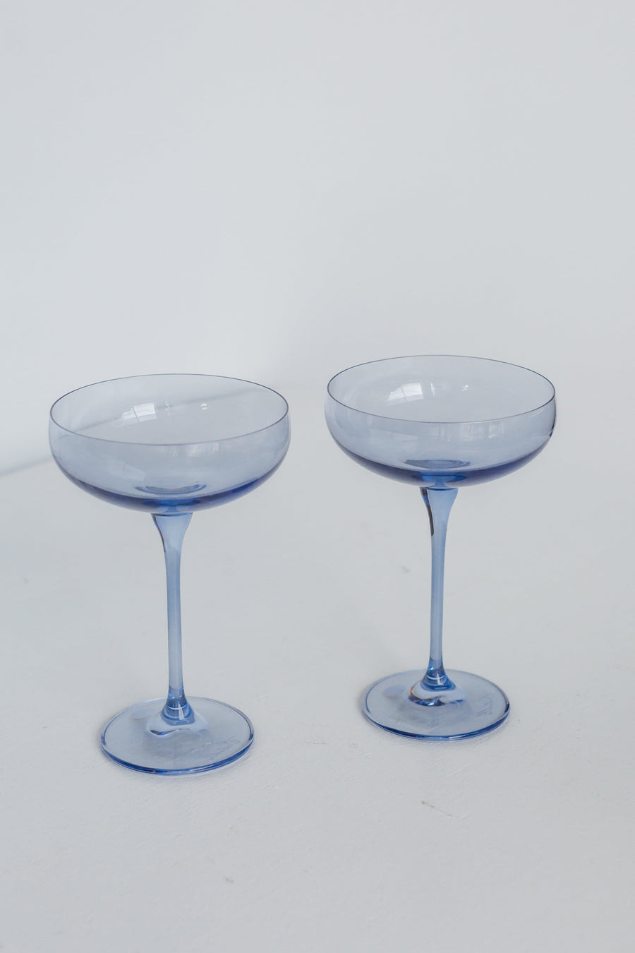 Elegant cobalt blue champagne coupes set for sophisticated celebrations and upscale events