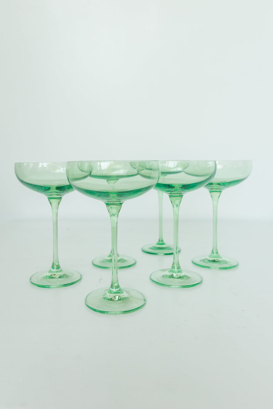 Mint green champagne coupes elegantly displayed for sophisticated event decor and stylish table settings.