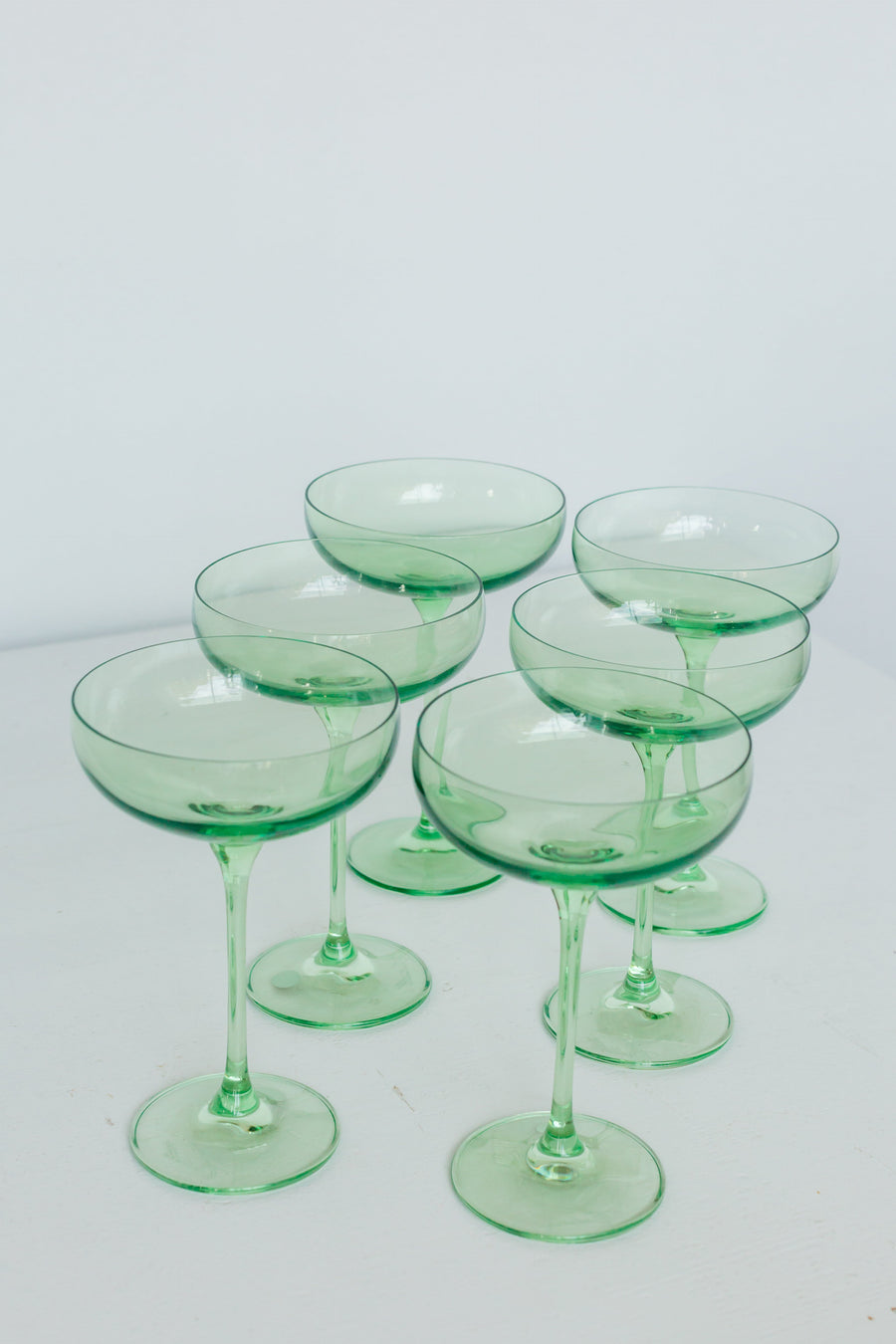 Mint green champagne coupes elegantly displayed for sophisticated event decor and stylish table settings.