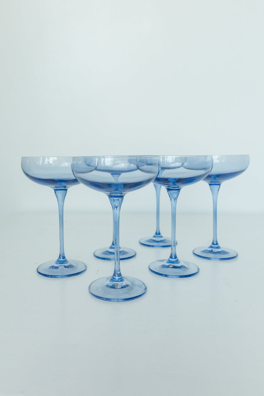 Elegant cobalt blue champagne coupes set for a luxurious celebration with refined glassware