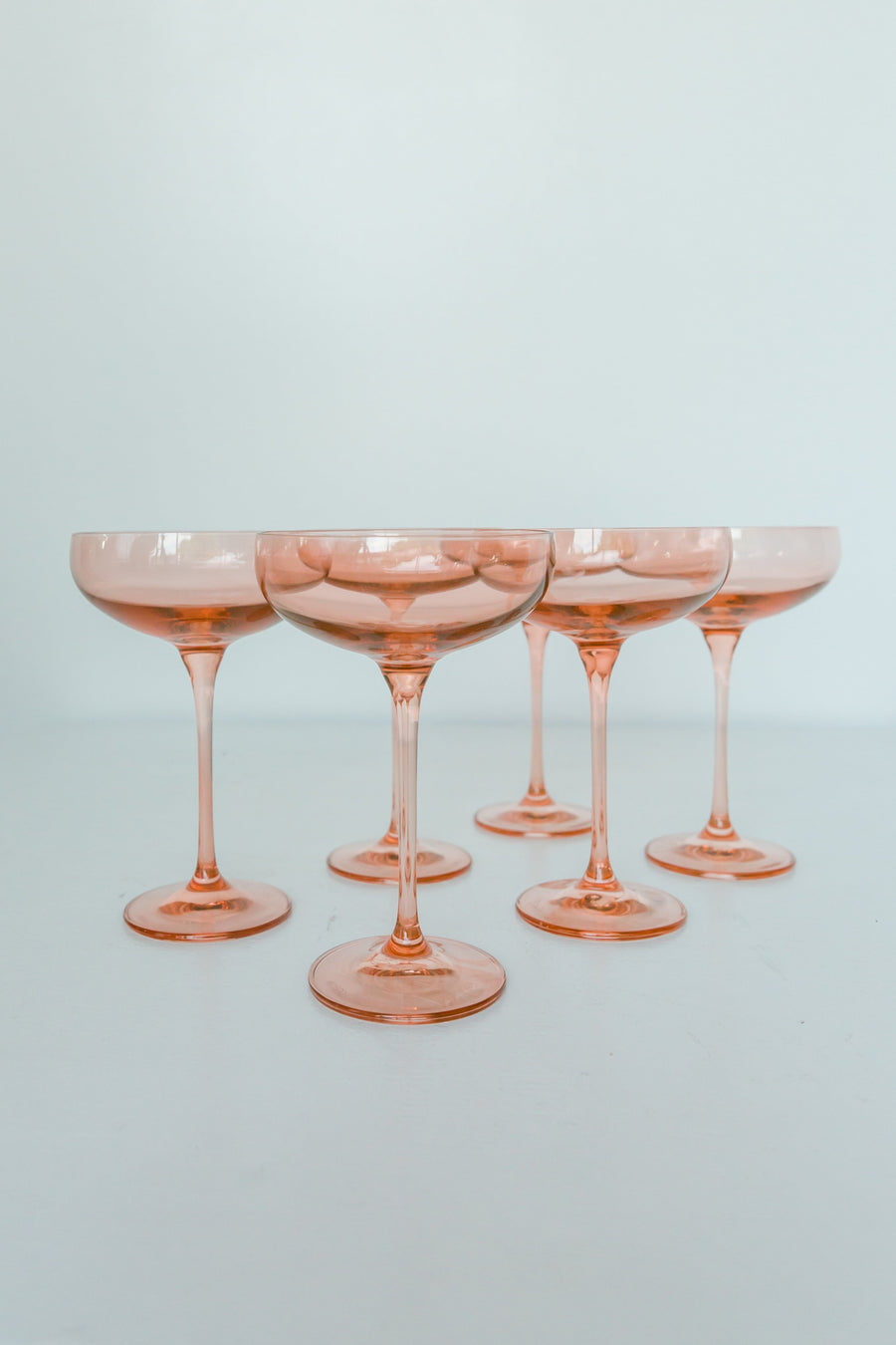 Elegant blush pink champagne coupes perfect for sophisticated celebrations and stylish toasts.