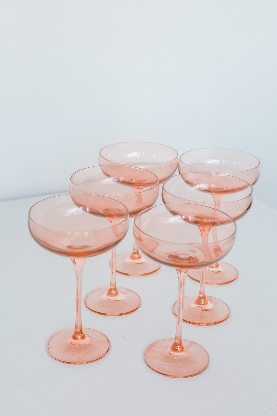 Elegant blush pink champagne coupes perfect for sophisticated celebrations and stylish toasts.