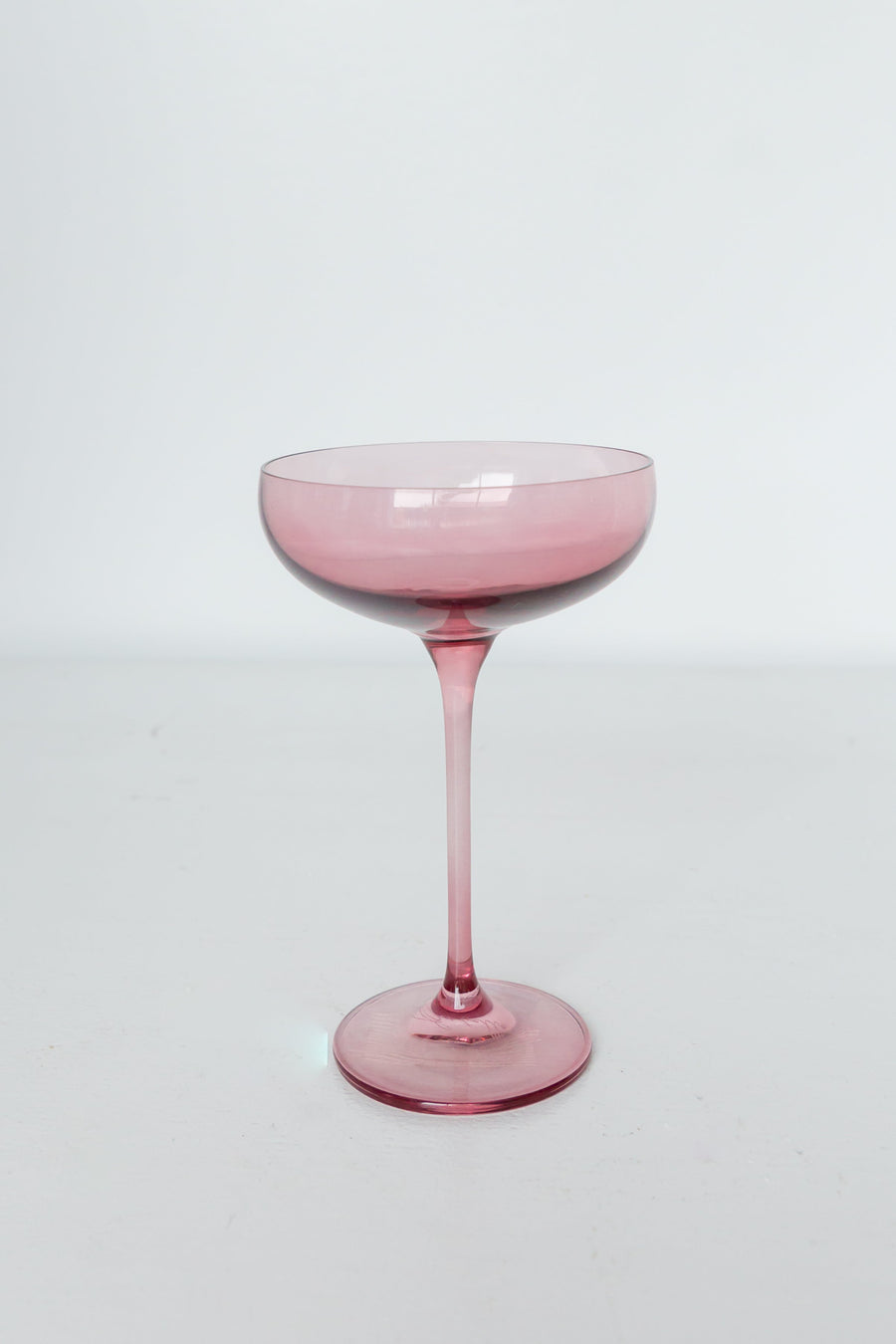 Elegant rose bouquet paired with fine champagne glass, perfect for sophisticated celebrations and romantic occasions.