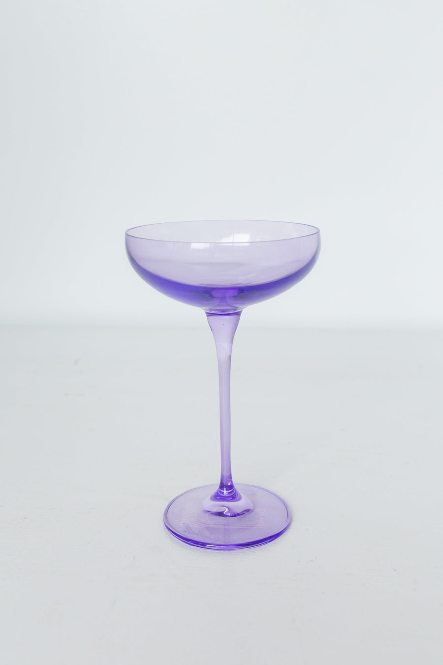 Lavender-themed setting with elegant champagne coupes, perfect for sophisticated celebrations and décor.