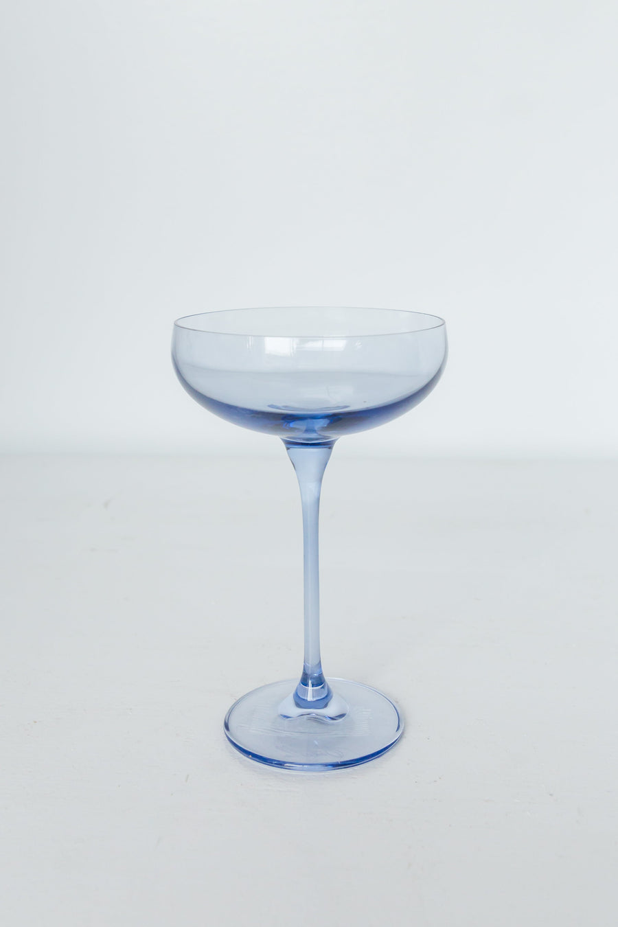 Elegant cobalt blue champagne coupes set for a luxurious celebration with refined glassware