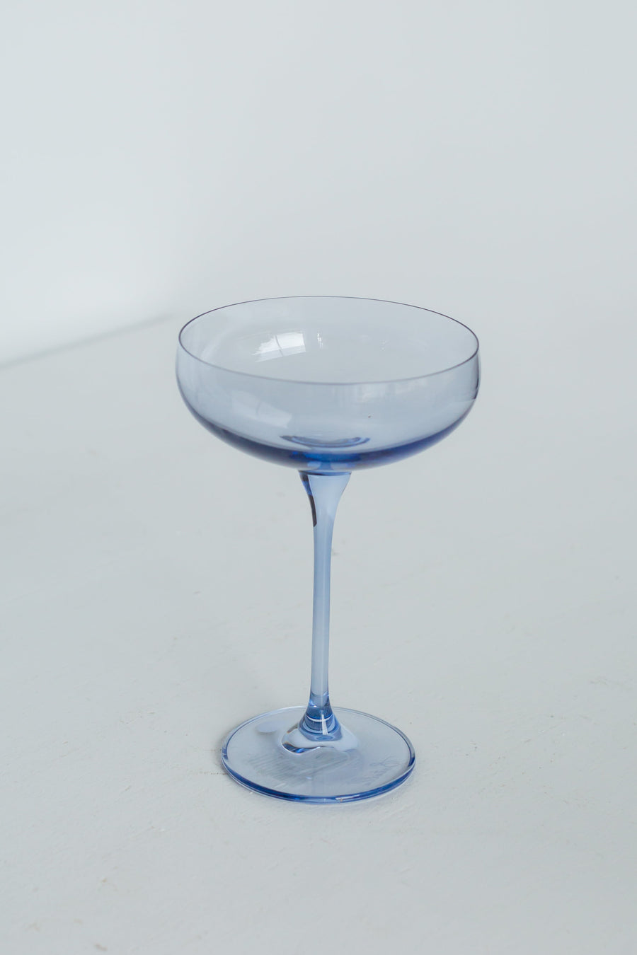 Elegant cobalt blue champagne coupes set for a luxurious celebration with refined glassware