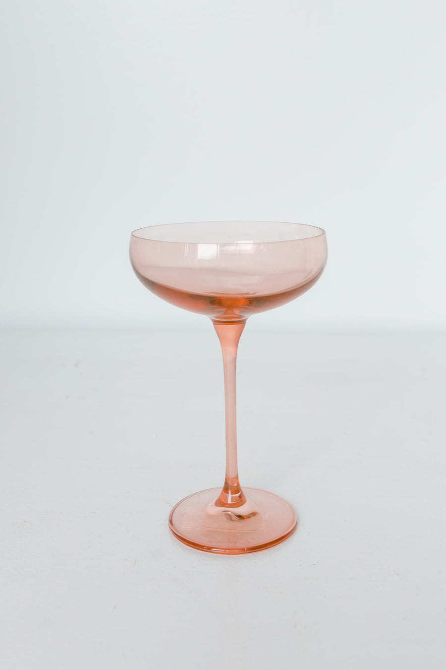 Elegant blush pink champagne coupes perfect for sophisticated celebrations and stylish toasts.