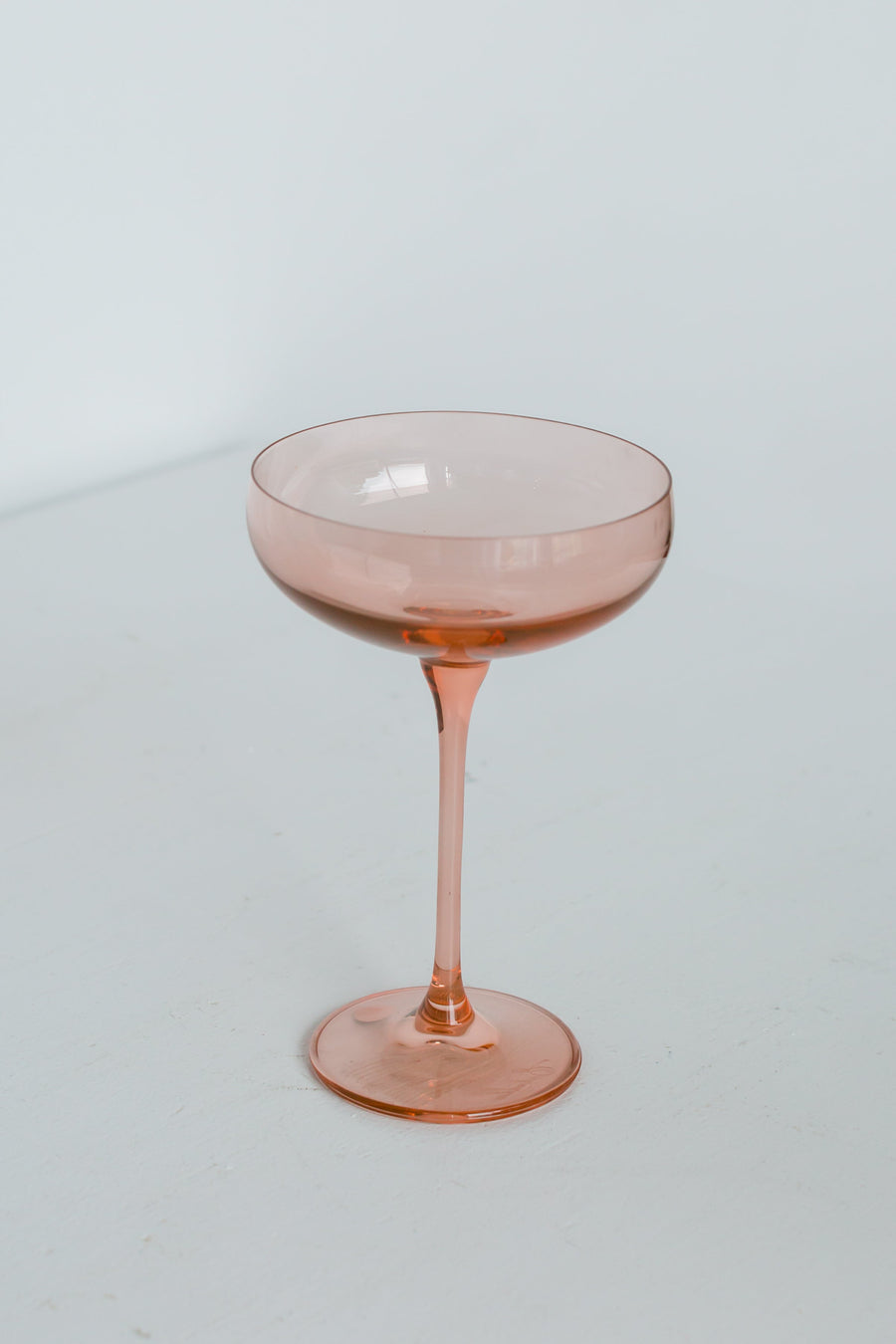Elegant blush pink champagne coupes perfect for sophisticated celebrations and stylish toasts.
