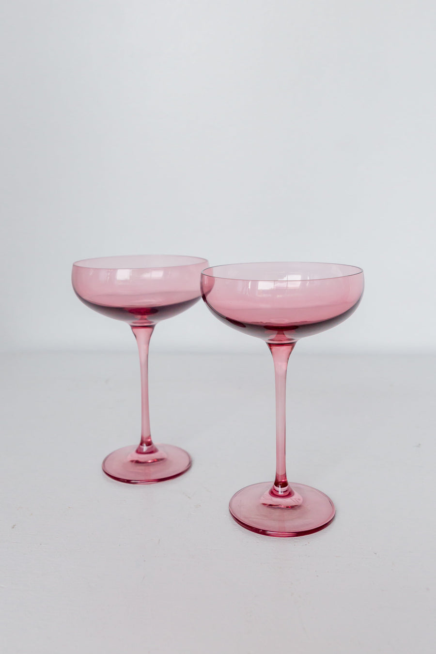 Elegant rose bouquet paired with fine champagne glass, perfect for sophisticated celebrations and romantic occasions.