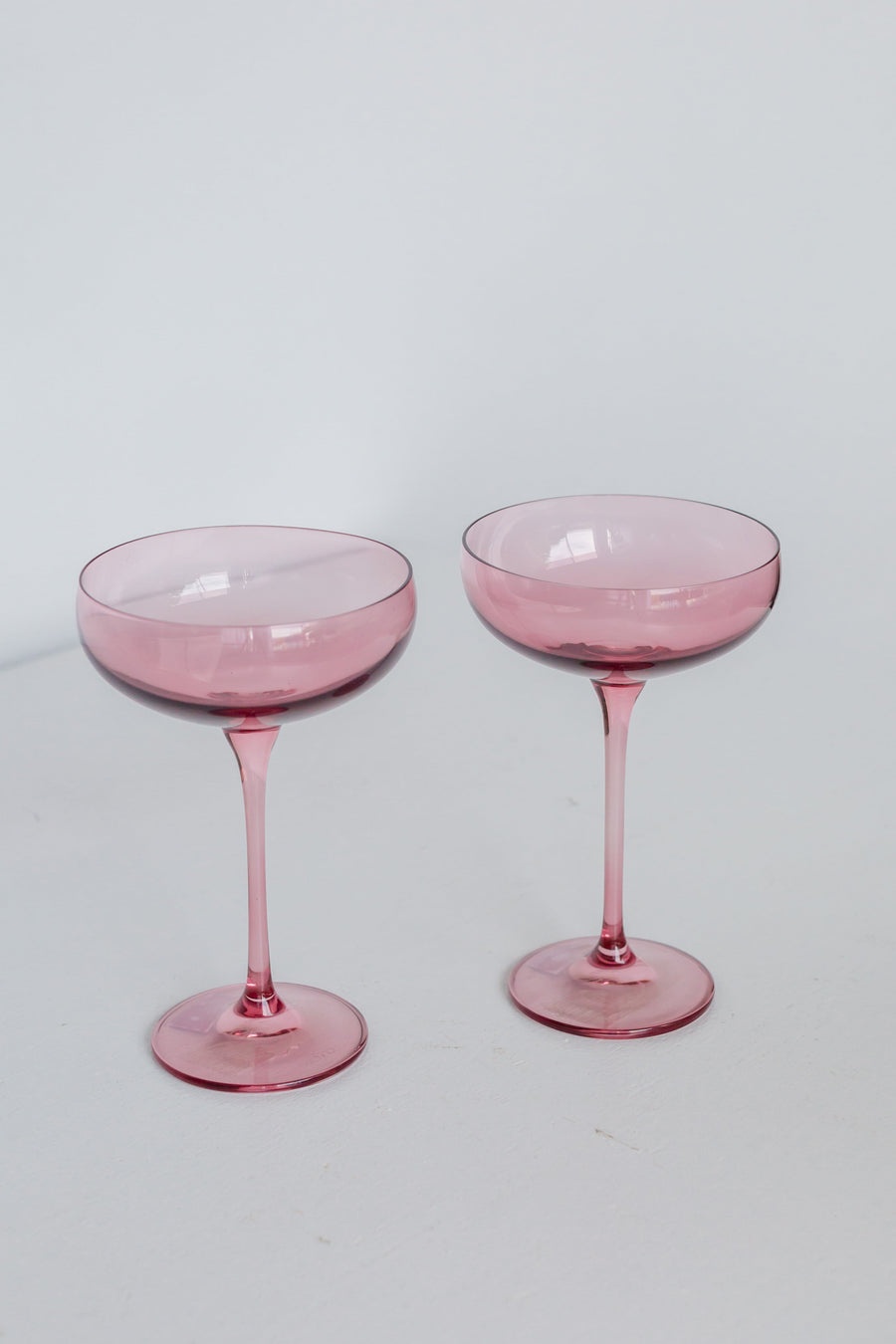 Elegant rose bouquet paired with fine champagne glass, perfect for sophisticated celebrations and romantic occasions.