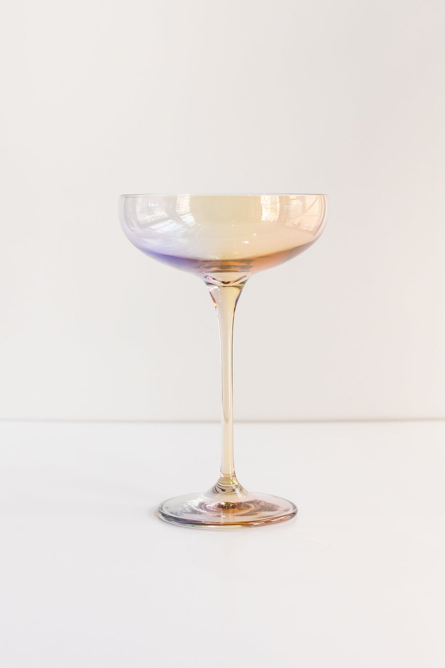 Elegant iridescent champagne bottle reflecting soft light, perfect for sophisticated event decor and celebrations.