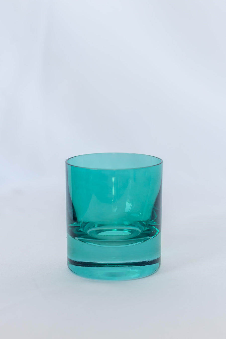 Emerald green rocks glass showcasing elegant design with vibrant color, perfect for sophisticated drinkware collections.