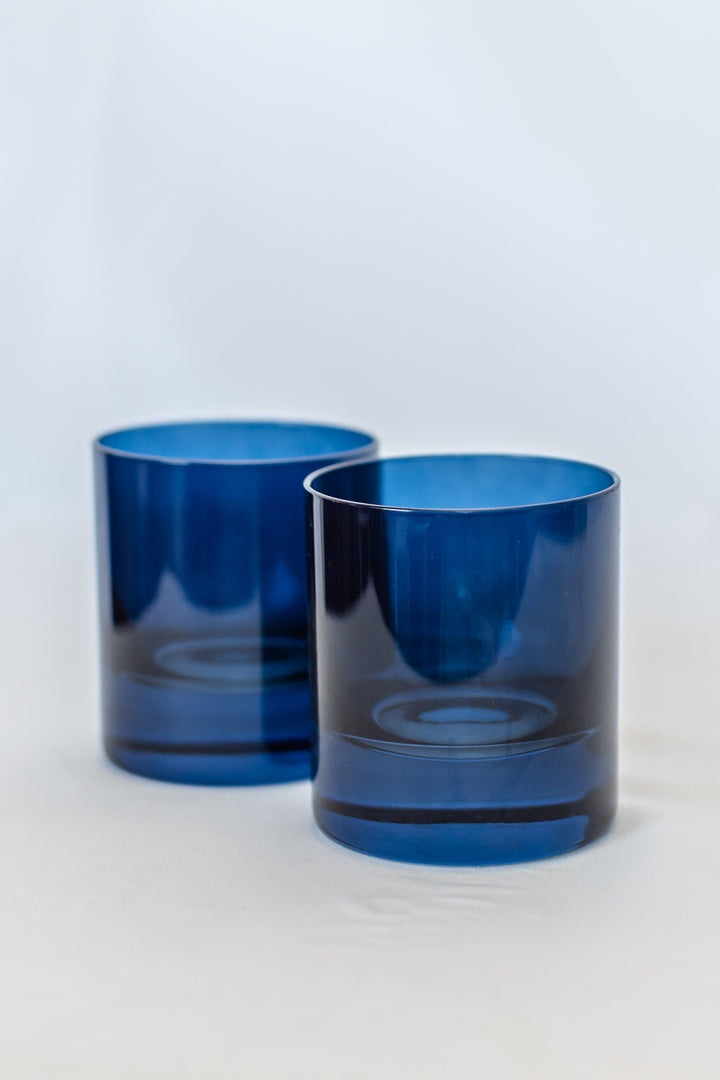 Elegant midnight blue rocks glass set perfect for refined home bar displays and sophisticated drink presentations.