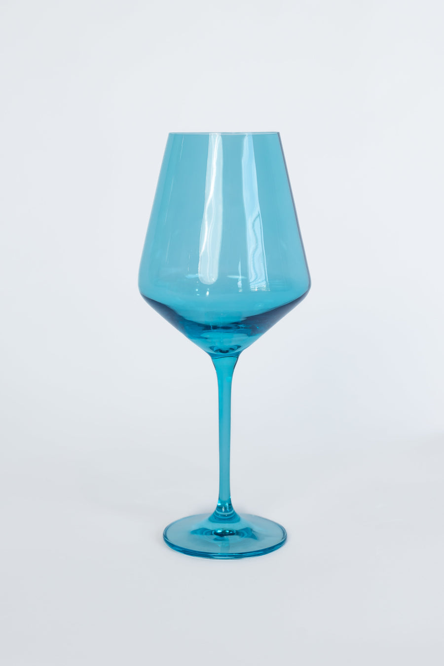 Elegant ocean blue wine glasses set on a pristine table, capturing the essence of luxury and coastal charm.