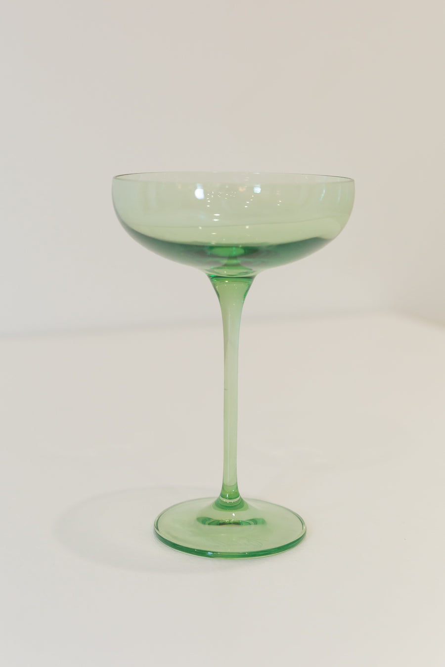 Mint green champagne coupes elegantly displayed for sophisticated event decor and stylish table settings.