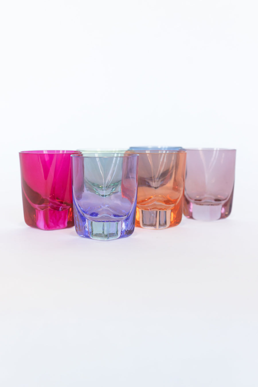 Vibrant colored shot glasses arranged elegantly for modern barware collection