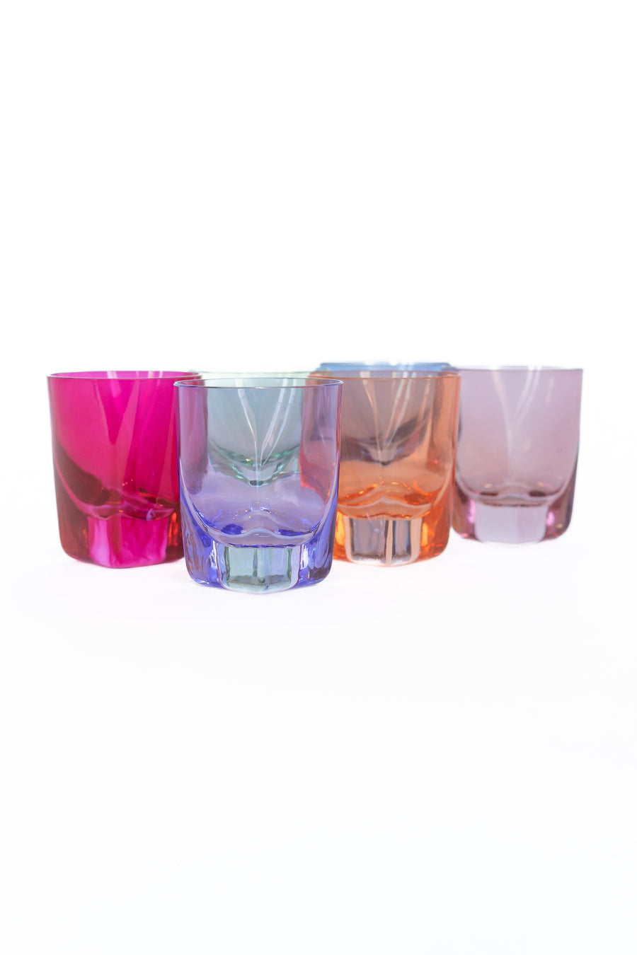 Vibrant colored shot glasses arranged elegantly for modern barware collection
