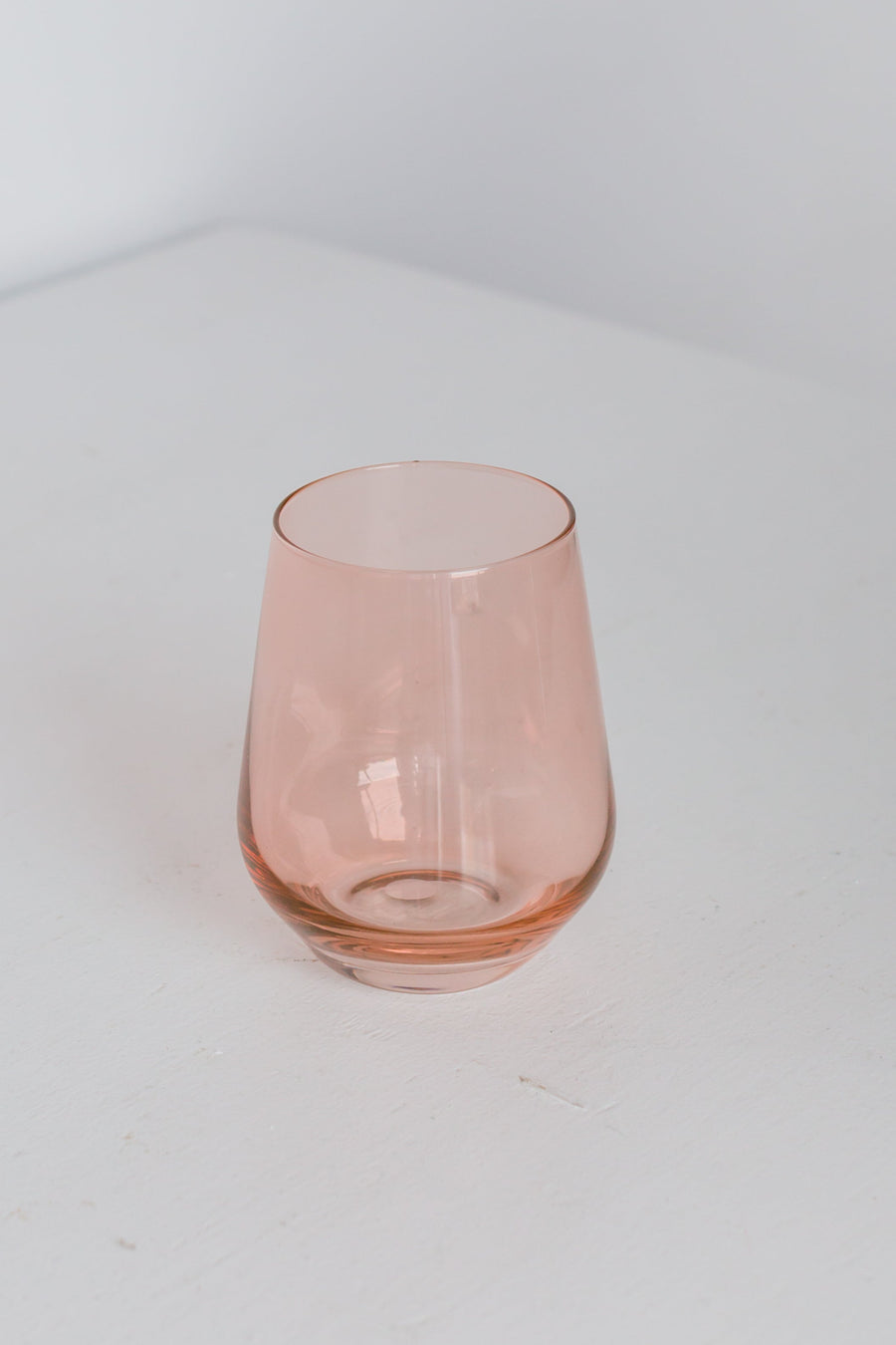 Elegant blush pink stemless wine glasses perfect for stylish entertaining and sophisticated table settings