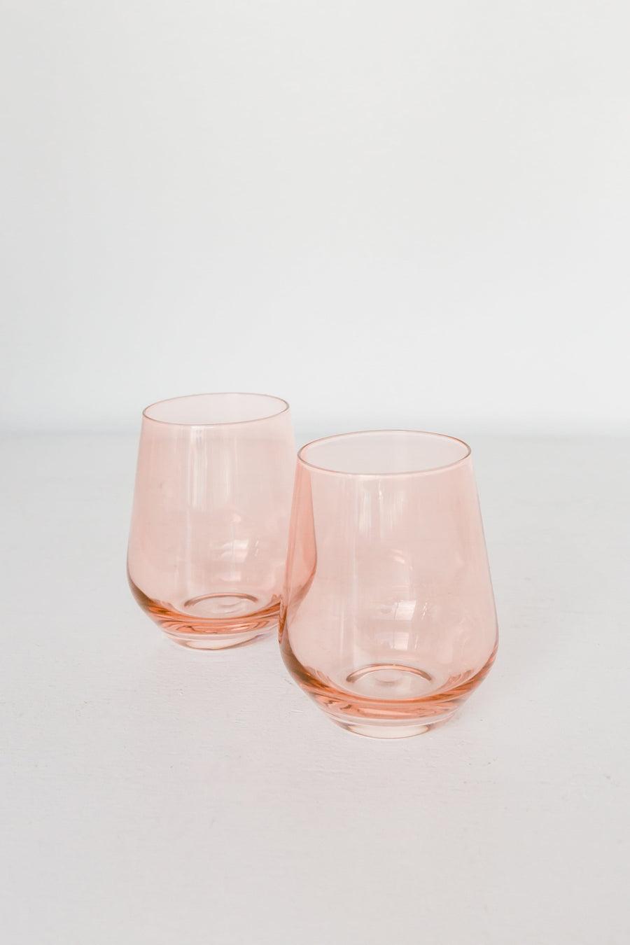 Elegant blush pink stemless wine glasses perfect for stylish entertaining and sophisticated table settings
