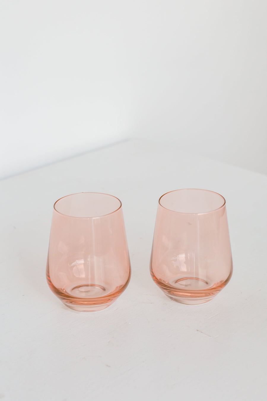 Elegant blush pink stemless wine glasses perfect for stylish entertaining and sophisticated table settings