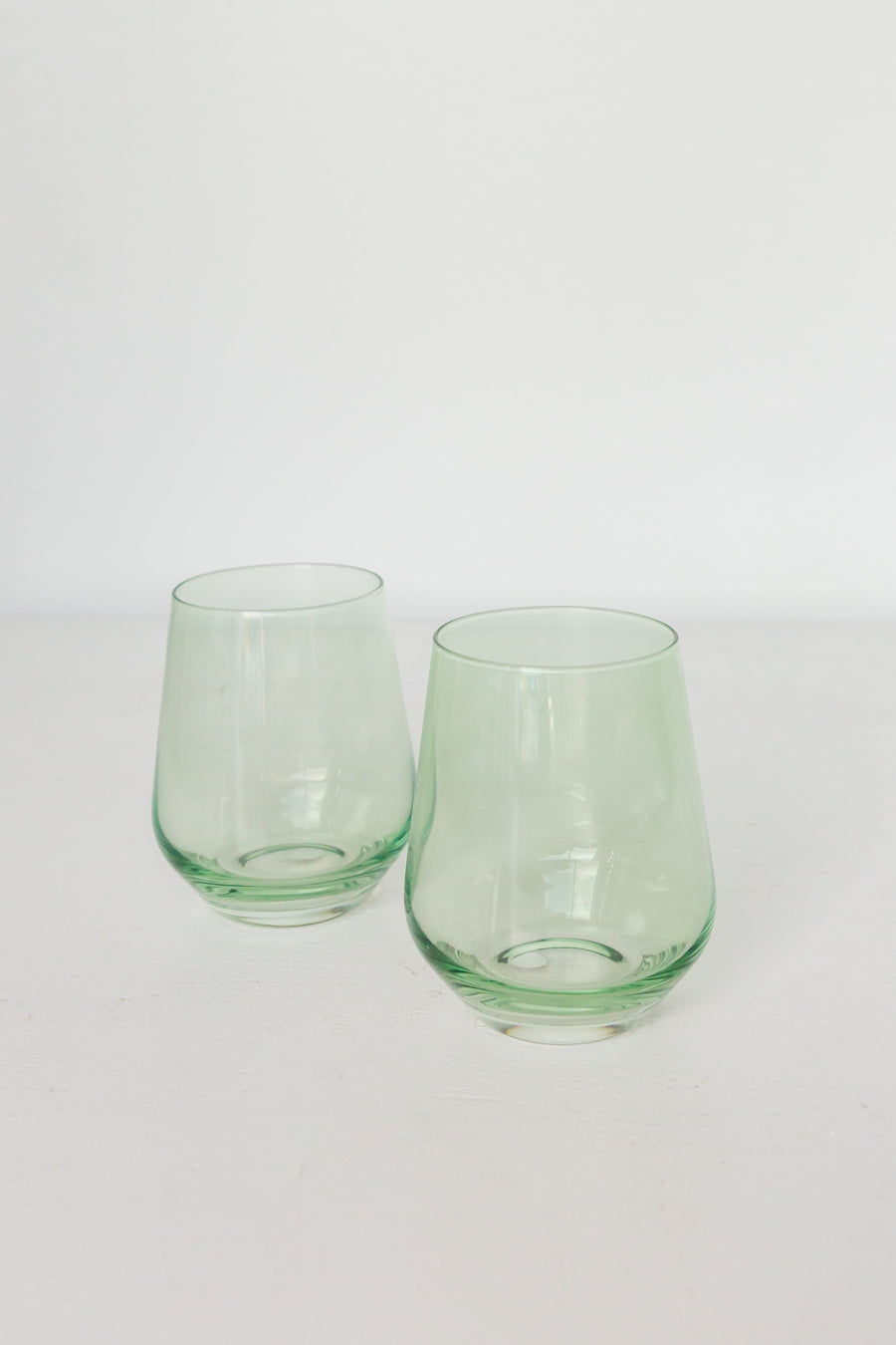 Elegant mint green stemless wine glasses perfect for stylish entertaining and modern table settings.