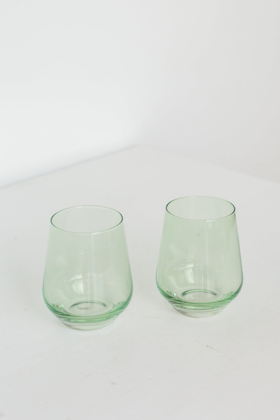 Elegant mint green stemless wine glasses perfect for stylish entertaining and modern table settings.