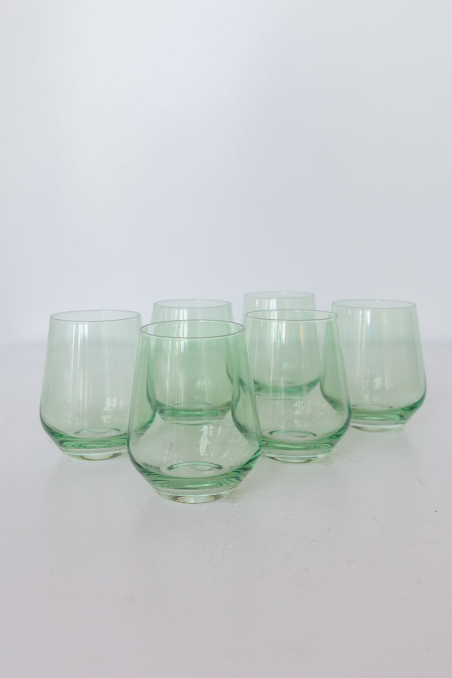 Elegant mint green stemless wine glasses perfect for stylish entertaining and modern table settings.