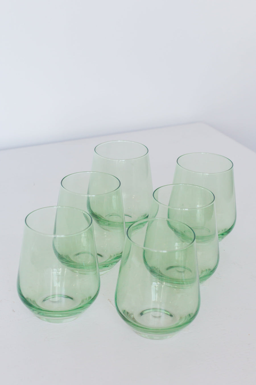 Elegant mint green stemless wine glasses perfect for stylish entertaining and modern table settings.