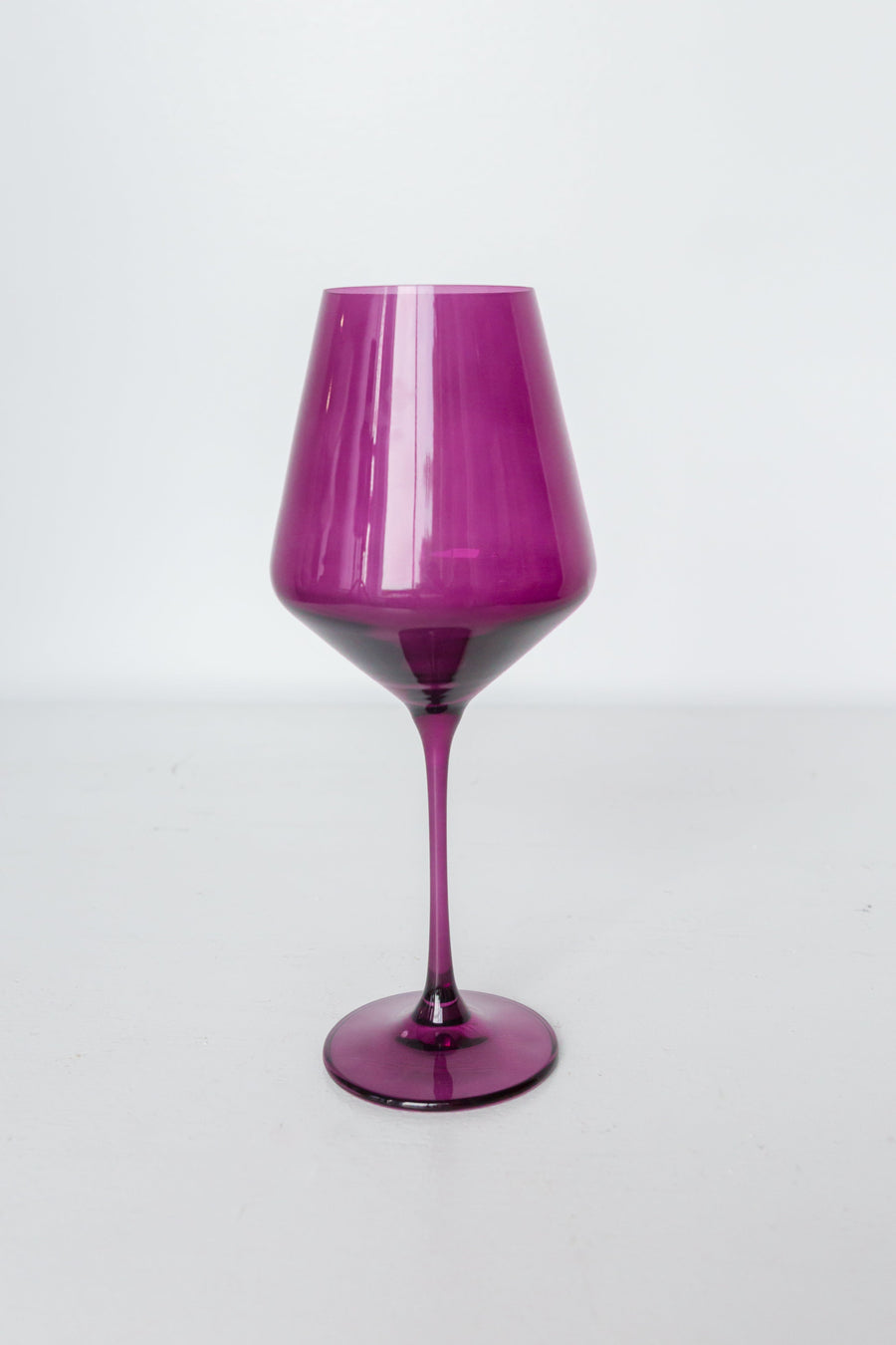 Elegant stemware showcasing vibrant colored wine, perfect for enhancing any formal dining experience.