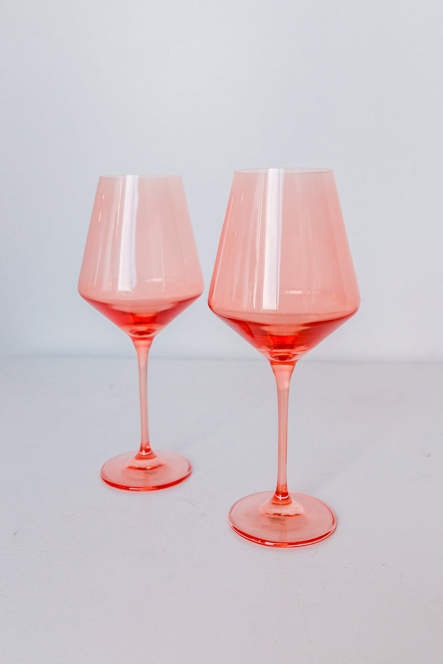 Colored wine stemware in peach fuzz hue enhancing elegant dining experiences