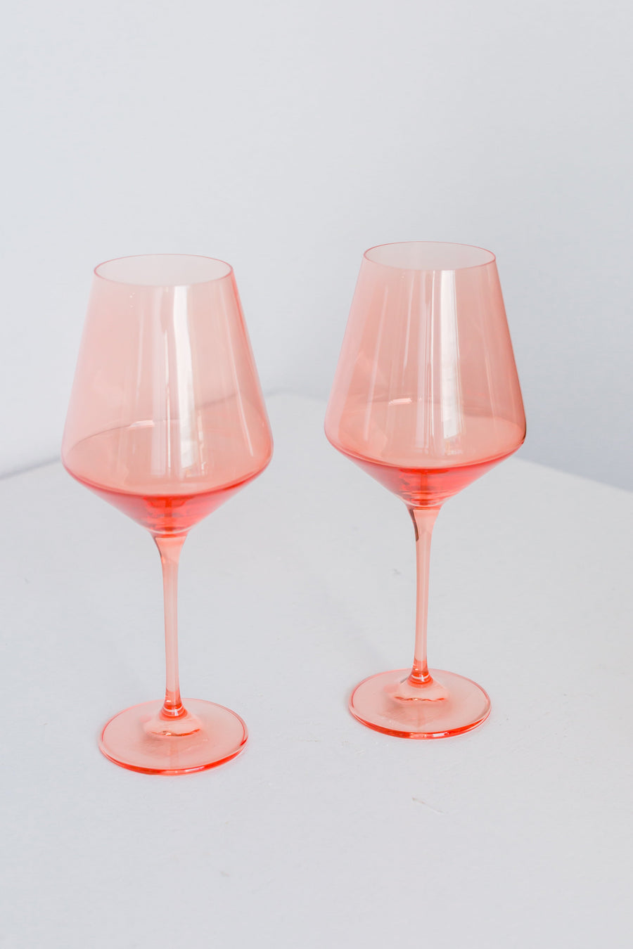 Colored wine stemware in peach fuzz hue enhancing elegant dining experiences