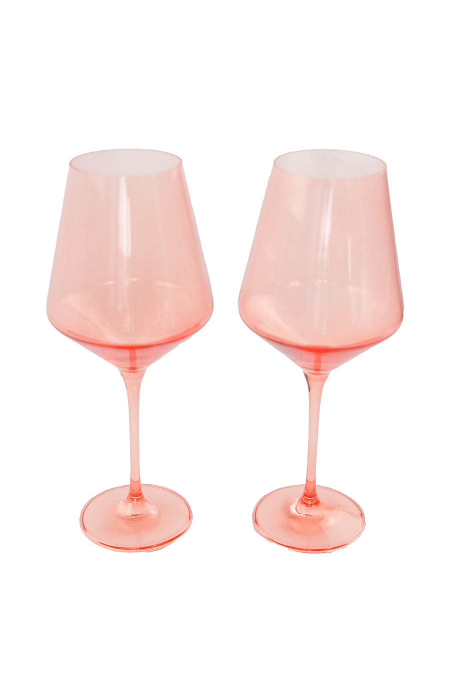 Colored wine stemware in peach fuzz hue enhancing elegant dining experiences